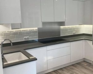 A kitchen in Southampton that has had new white wall tiles installed as part of a refurbishment.