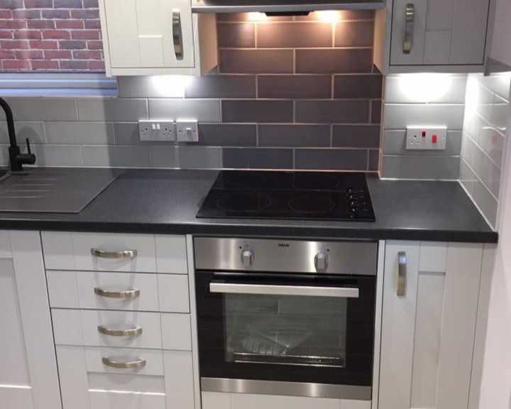 A kitchen installation featuring an integrated oven with hob and extractor fan in Southampton