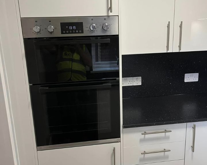 An integrated oven and microwave in a new kitchen installation in Southampton.