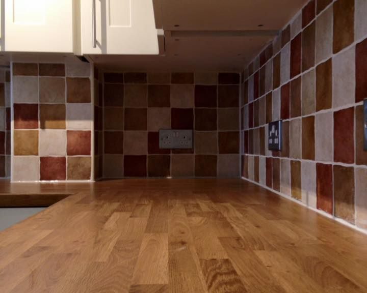 Orange, brown and white wall tiles installed in a kitchen in Southampton